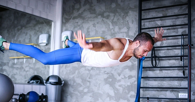 A man performing a Superman push-up | Trainest