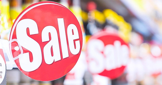 A "sale" sign in a grocery store | Trainest