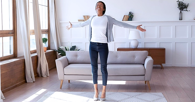 Woman Stretching in Living Room | Trainest