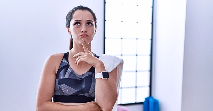 A woman thinking while working out | Trainest