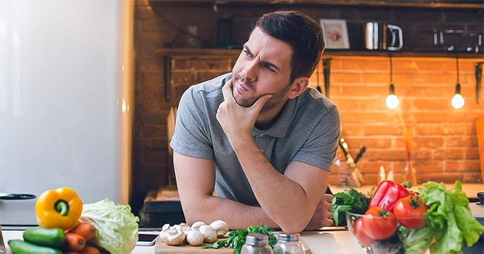 A man thinking while in the kitchen | Trainest