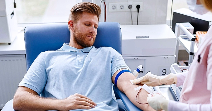 A man getting his blood drawn | Trainest