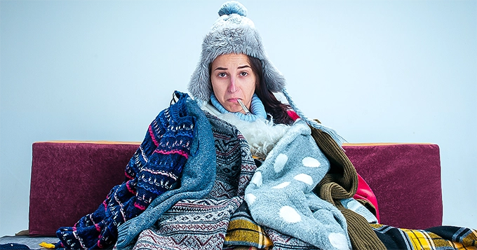 Someone sick indoors in winter clothes | Trainest