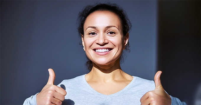 A healthy-looking woman smiling | Trainest