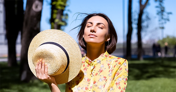 A woman basking in the sunlight | Trainest