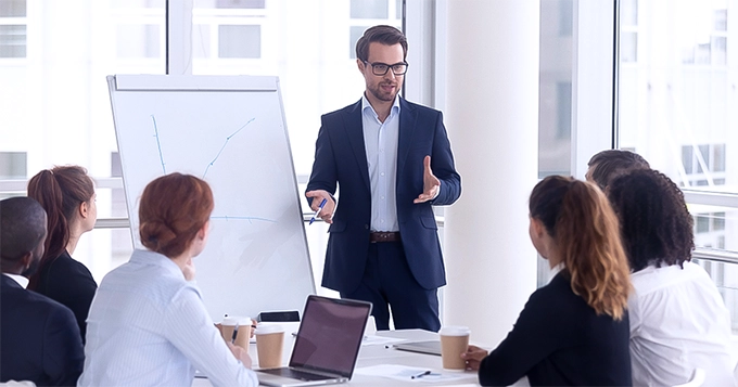 Sharp-dressed man giving a presentation | Trainest