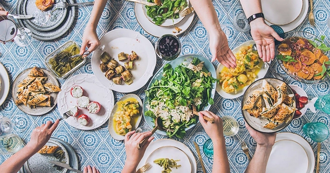 A table filled with various plates of food | Trainest