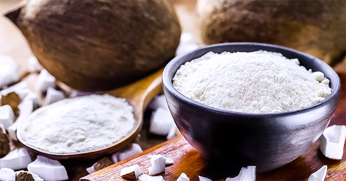 Coconuts and a bowl of coconut powder | Trainest 