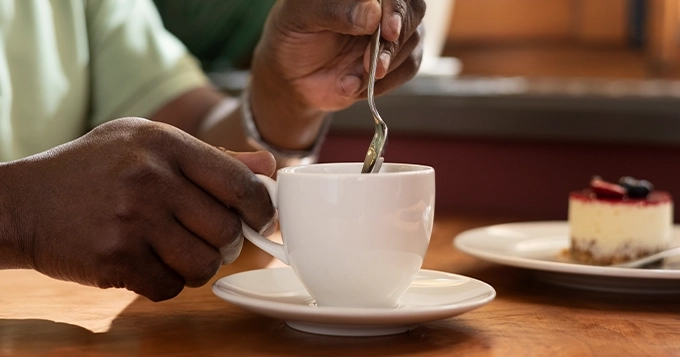 Someone stirring a cup of tea | Trainest 