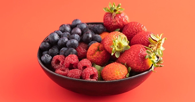 A bowl of different varieties of berries | Trainest 