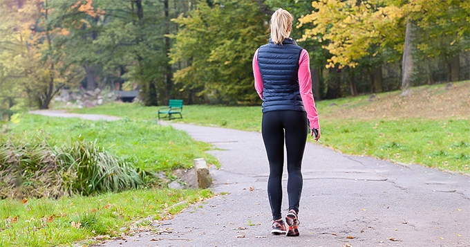 A woman walking in a park | Trainest 