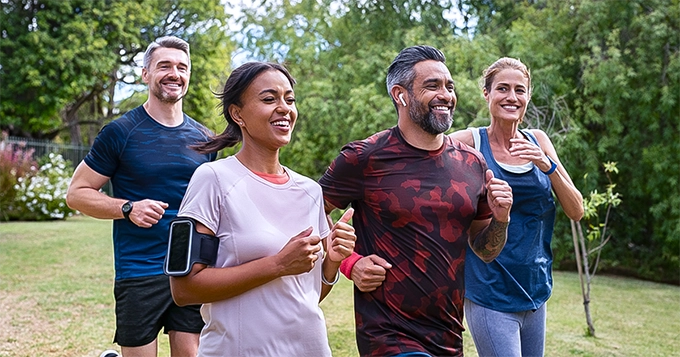 A group of people walking in a park | Trainest 