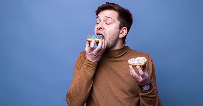 Someone eating two doughnuts at the same time | Trainest 