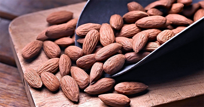 Roasted almonds on a board | Trainest 