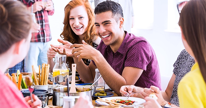 A group of people eating together | Trainest 