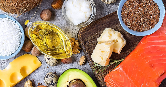 Uncooked sources of healthy fats on top of a table | Trainest 