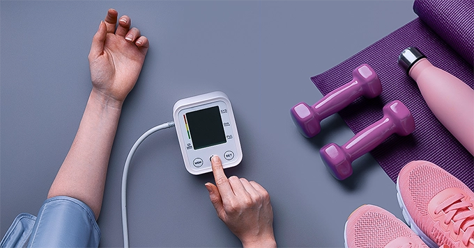 A fitness enthusiast checking their blood pressure | Trainest 