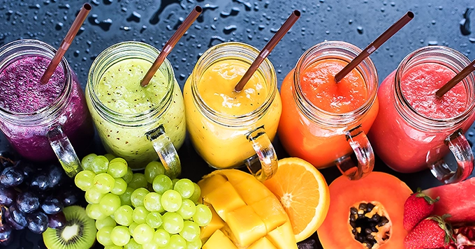 A colorful array of healthy fruit smoothies | Trainest
