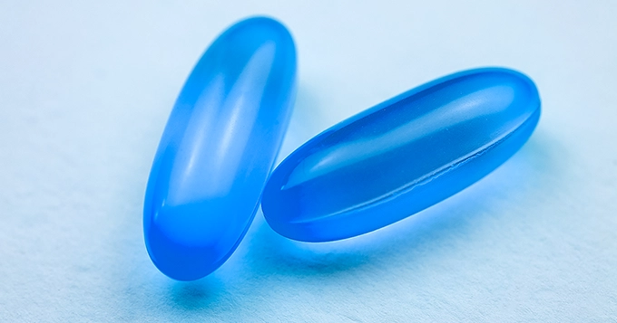 Two blue soft-gel capsules | Trainest 