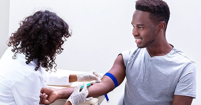 A young man getting his blood drawn | Trainest 