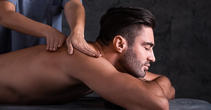 A fit person getting a massage | Trainest 