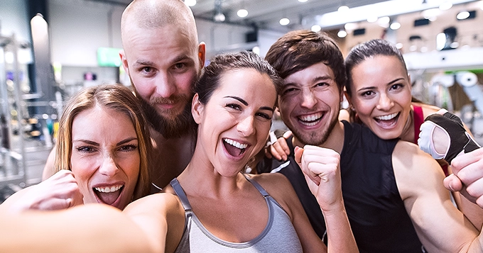 A selfie of happy group of people in the gym | Trainest