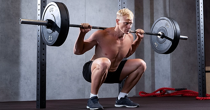 Someone doing barbell back squat | Trainest