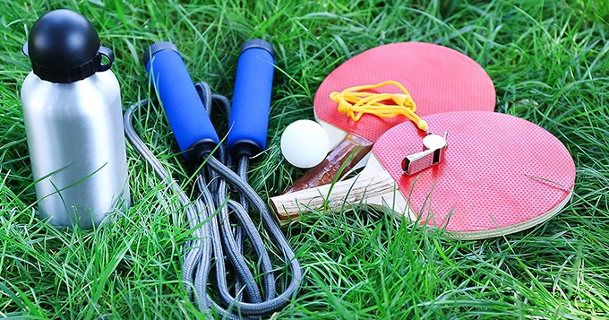Different sports equipment laid out on the grass | Trainest
