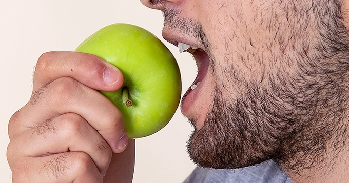 A person eating an apple | Trainest