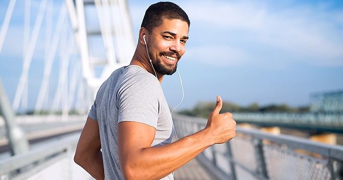 Someone looking happy while exercising outdoors | Trainest