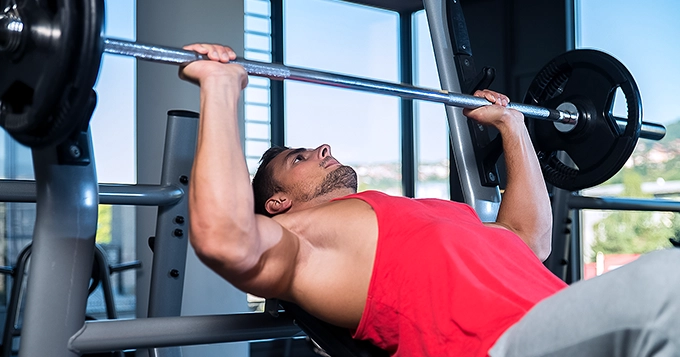 Someone doing an incline bench press | Trainest