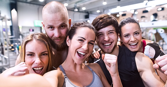 Group of happy people taking a selfie at the gym | Trainest