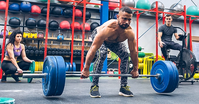 Someone performing Trap Bar Squats in a gym | Trainest